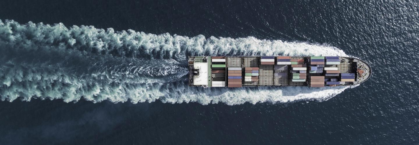 boat transporting containers over sea