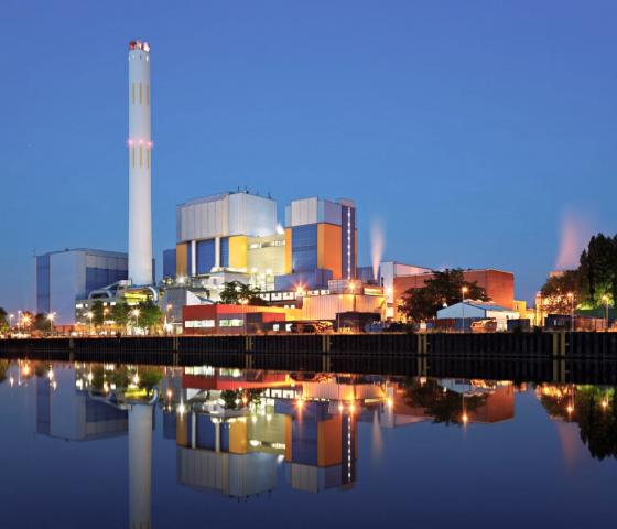 Biomass power plant in the evening with reflection on water